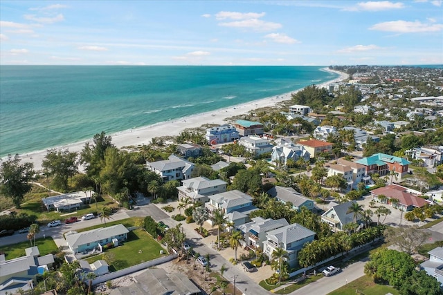 birds eye view of property with a water view and a view of the beach