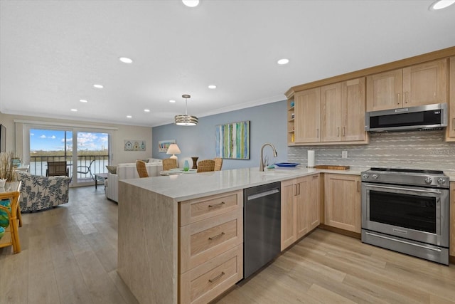 kitchen with light brown cabinetry, kitchen peninsula, and appliances with stainless steel finishes