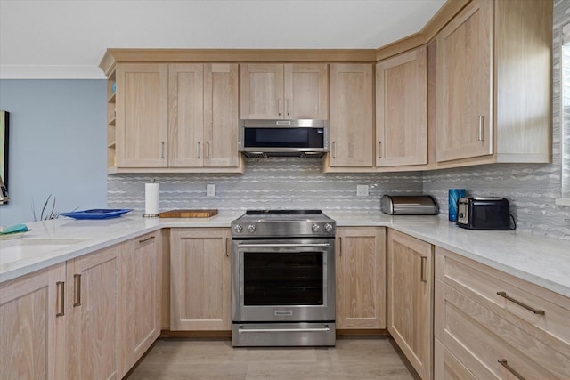 kitchen featuring appliances with stainless steel finishes, light brown cabinetry, and backsplash