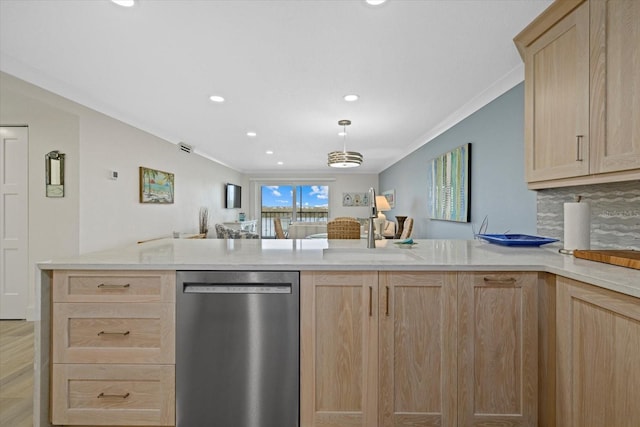 kitchen featuring light brown cabinetry, stainless steel dishwasher, and kitchen peninsula