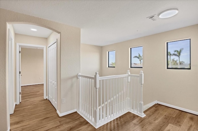 hall with hardwood / wood-style floors