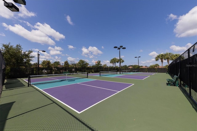 view of tennis court with basketball hoop