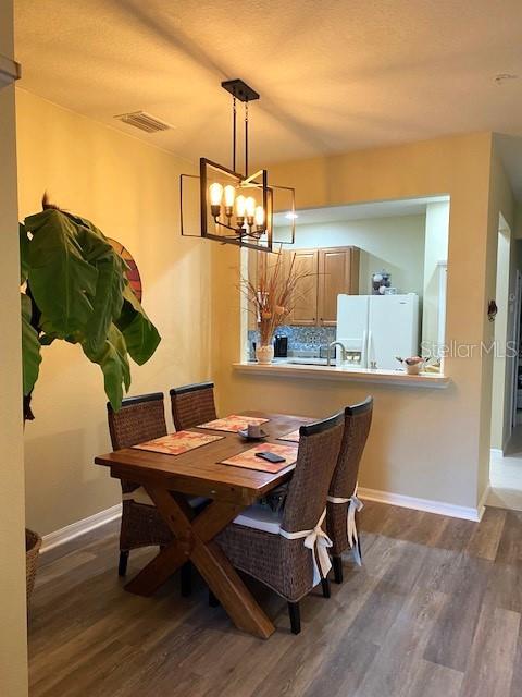 dining area with dark wood-type flooring