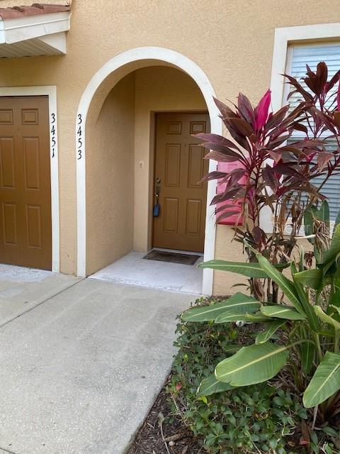 doorway to property featuring stucco siding