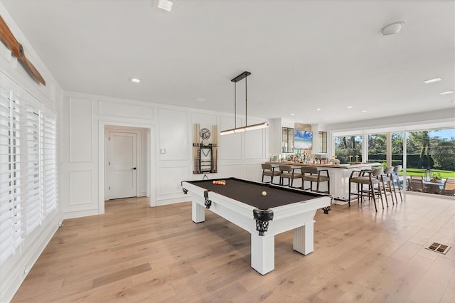 game room with pool table and light hardwood / wood-style floors