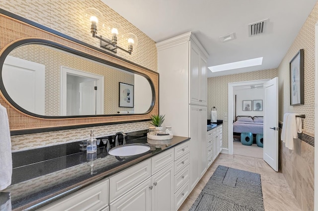 bathroom featuring vanity and a skylight