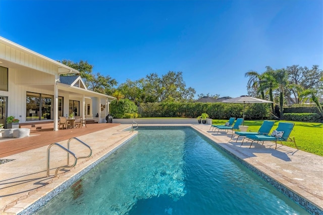 view of swimming pool with a yard and a patio