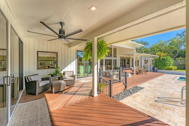 deck with an outdoor living space and ceiling fan