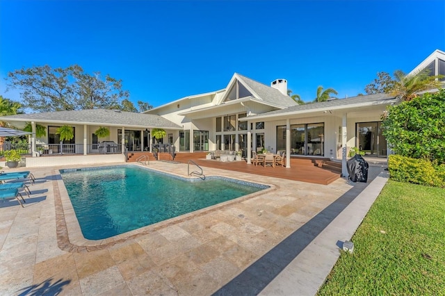 view of pool featuring a wooden deck and a patio area