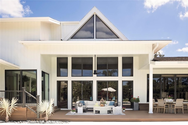 rear view of house featuring an outdoor living space and a deck