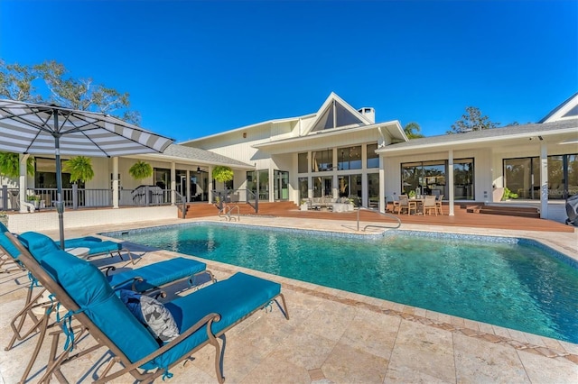 view of swimming pool with a patio and a wooden deck