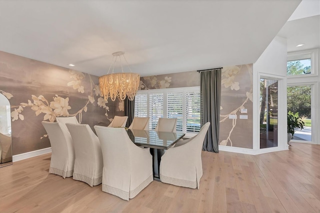 dining room featuring an inviting chandelier and light hardwood / wood-style flooring