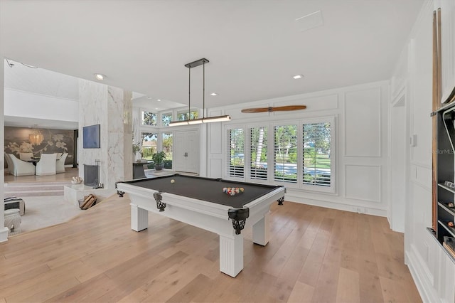 recreation room featuring ceiling fan, billiards, a healthy amount of sunlight, and light hardwood / wood-style flooring