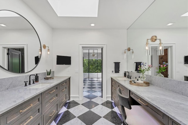 bathroom with vanity and a skylight