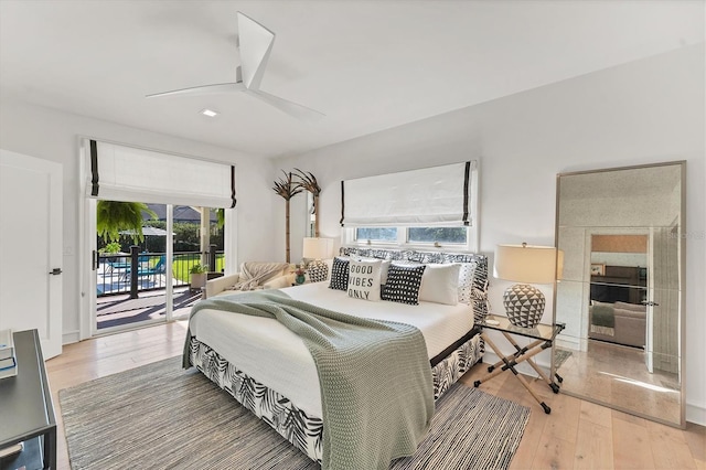 bedroom with hardwood / wood-style flooring, access to outside, and ceiling fan