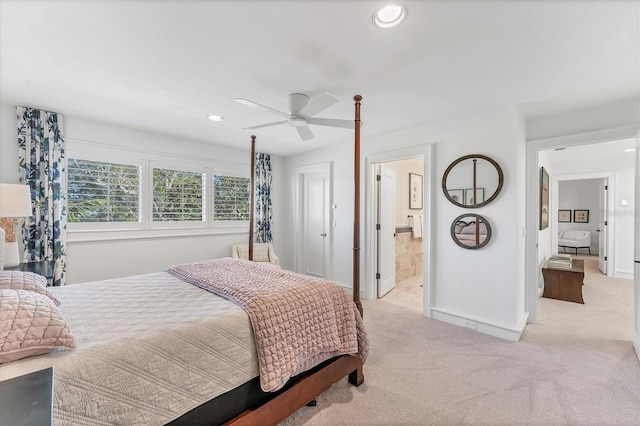 carpeted bedroom featuring connected bathroom and ceiling fan