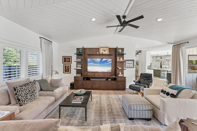 living room featuring wood ceiling, lofted ceiling, ceiling fan with notable chandelier, and light wood-type flooring