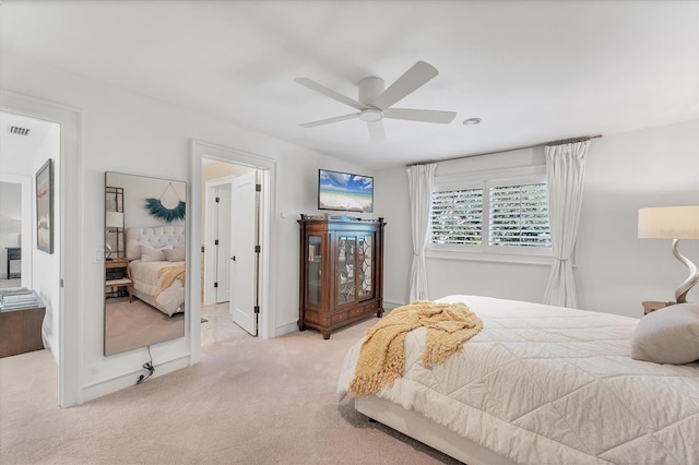 bedroom featuring light carpet and ceiling fan