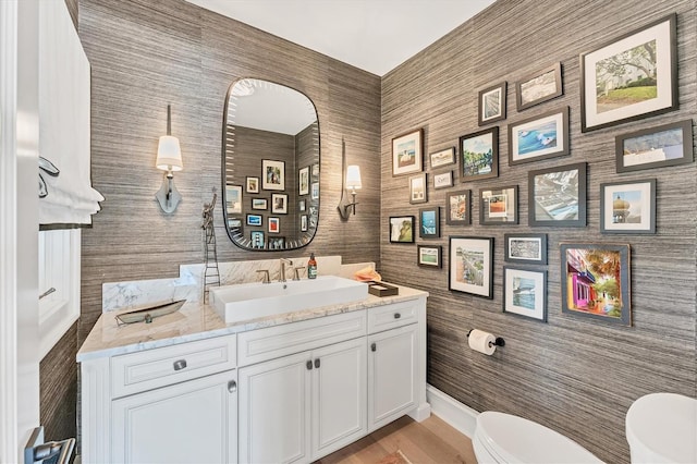 bathroom featuring vanity and toilet