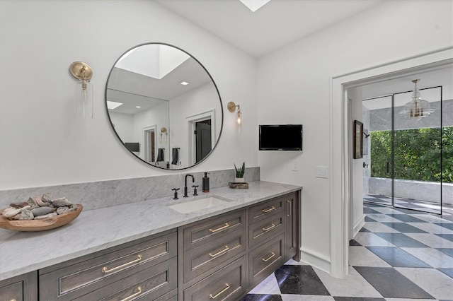 bathroom with vanity and a skylight