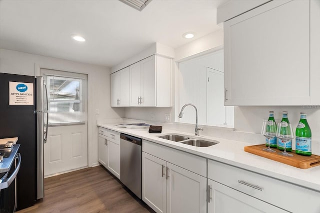 kitchen featuring stainless steel appliances, sink, white cabinets, and dark hardwood / wood-style flooring