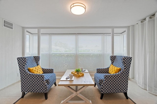 sitting room with light tile patterned floors and a wealth of natural light