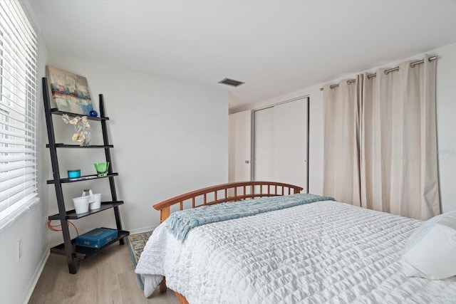 bedroom featuring light hardwood / wood-style floors and a closet