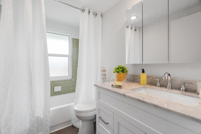 full bathroom with vanity, toilet, and shower / bath combo with shower curtain