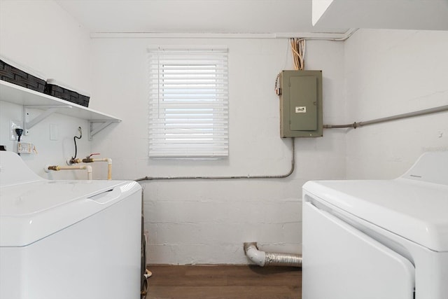 washroom with electric panel, separate washer and dryer, and hardwood / wood-style floors