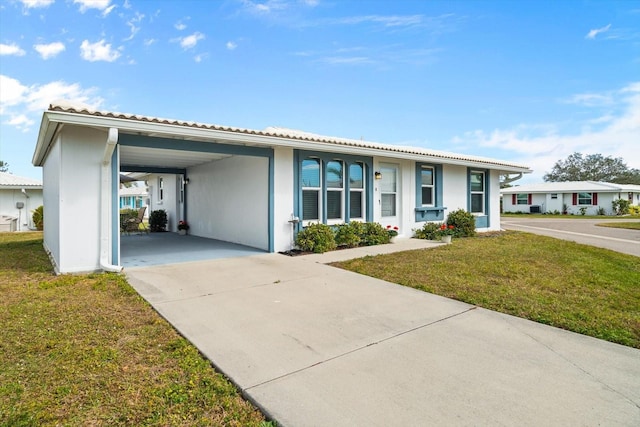 single story home featuring a carport and a front lawn