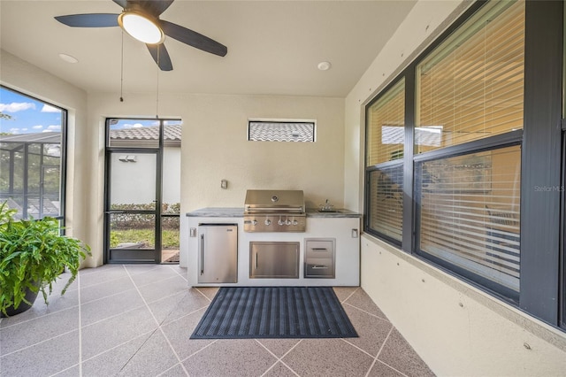 unfurnished sunroom with a healthy amount of sunlight, sink, and ceiling fan