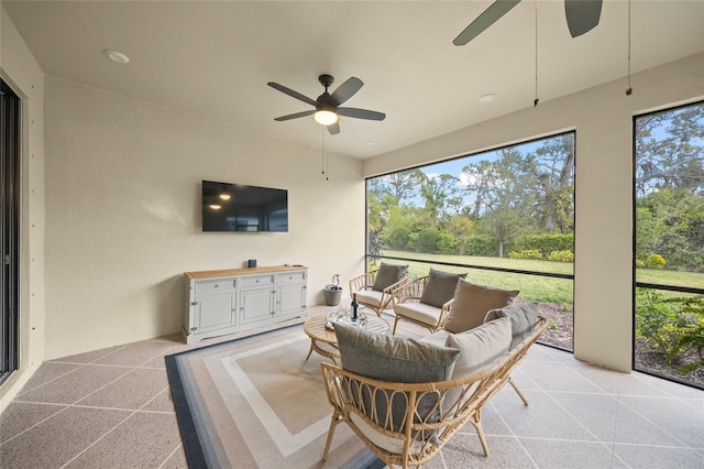 sunroom / solarium featuring ceiling fan