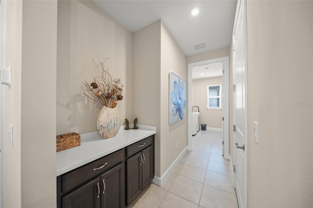 hall featuring light tile patterned floors