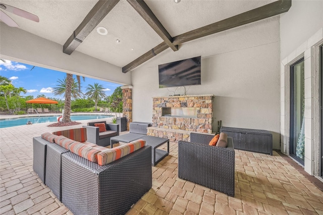 view of patio with an outdoor living space with a fireplace