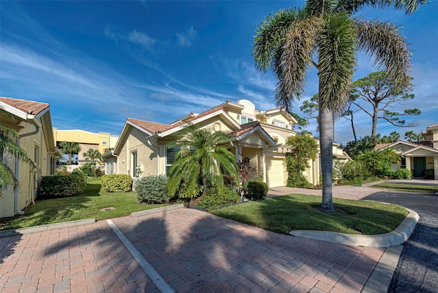 view of front of house with a garage and a front lawn