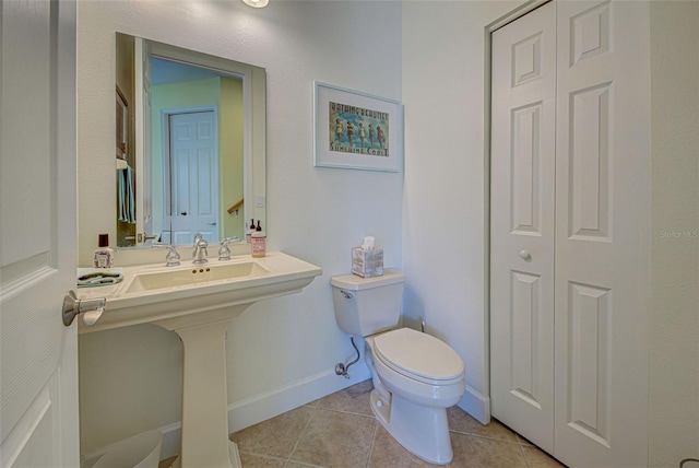 bathroom featuring tile patterned flooring and toilet