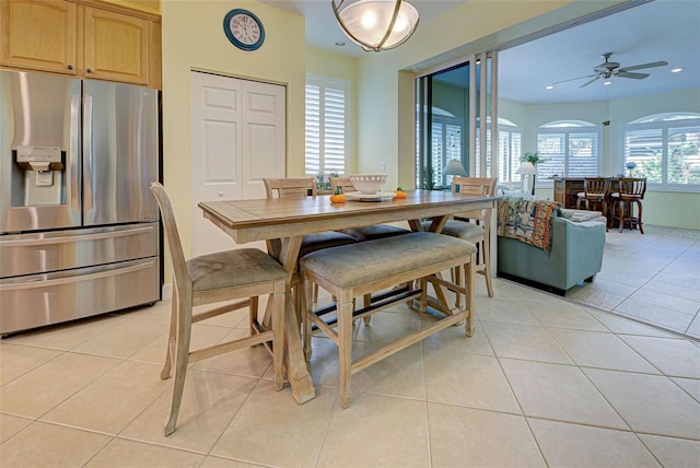 dining area with ceiling fan and light tile patterned floors