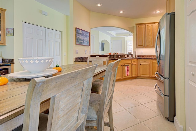 kitchen with wine cooler, light tile patterned floors, stainless steel fridge, and light brown cabinets