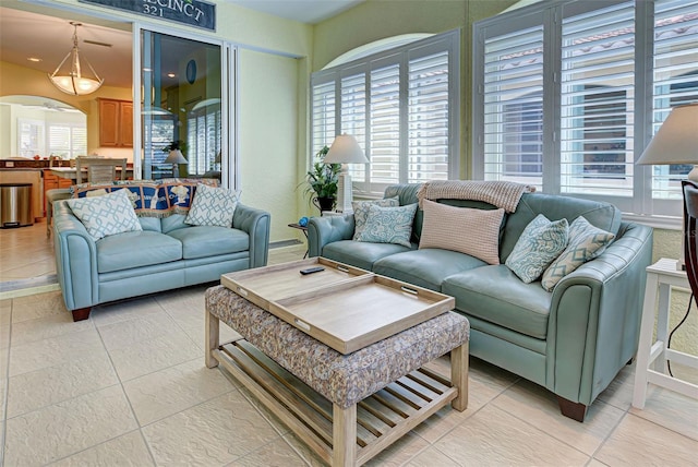 tiled living room with a wealth of natural light