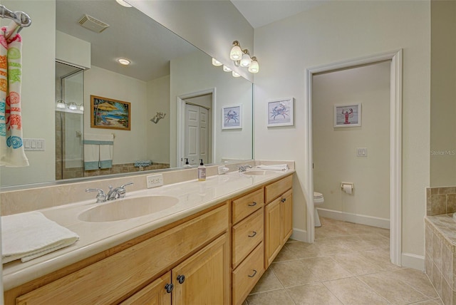 bathroom with vanity, toilet, and tile patterned flooring