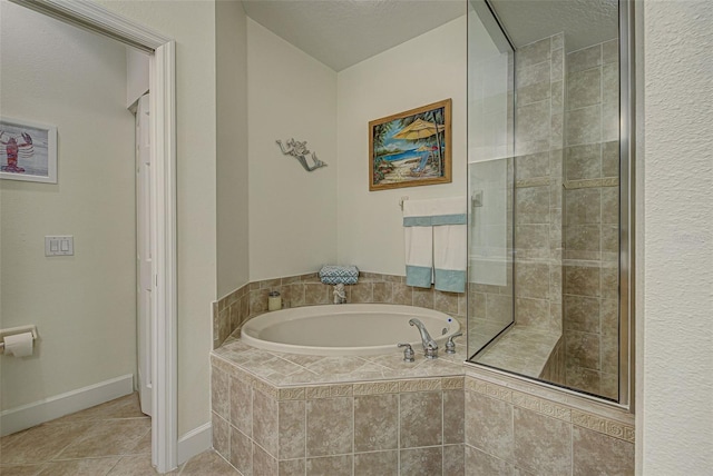 bathroom with tile patterned floors and tiled bath