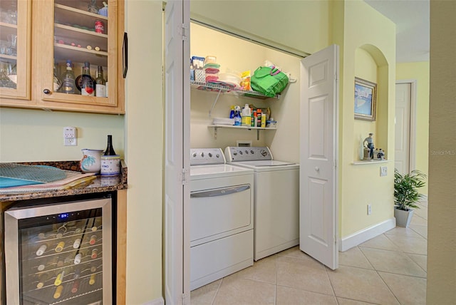 laundry room featuring bar, light tile patterned floors, beverage cooler, and washing machine and clothes dryer