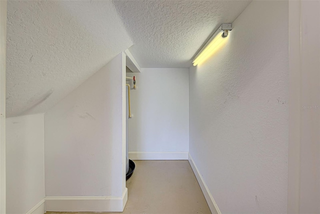 additional living space with a textured ceiling