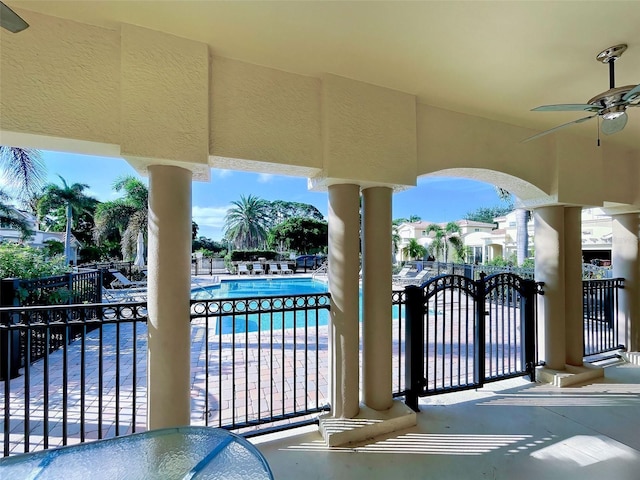 view of patio / terrace with a community pool and ceiling fan