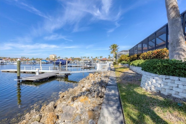 dock area featuring a water view and glass enclosure