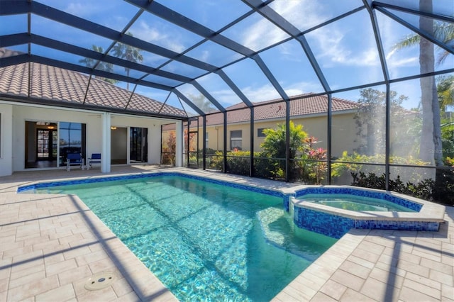 view of swimming pool featuring an in ground hot tub, a lanai, and a patio area