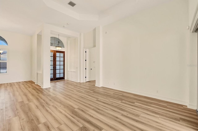 unfurnished room featuring light wood-type flooring and french doors