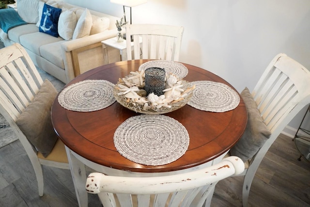 dining area featuring dark wood-type flooring