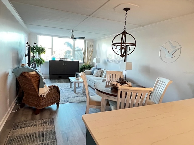 dining room featuring hardwood / wood-style flooring, crown molding, and ceiling fan