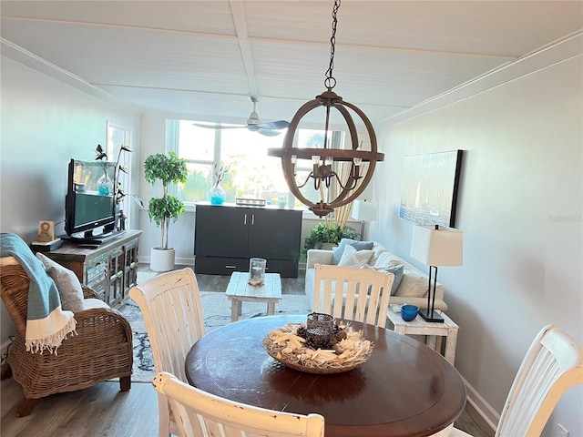 dining area with beamed ceiling and hardwood / wood-style floors